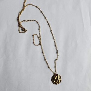 gold toned textured circular shaped charm necklace costume fashion jewelry